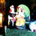 Mother and daughter in costume posing at family altar